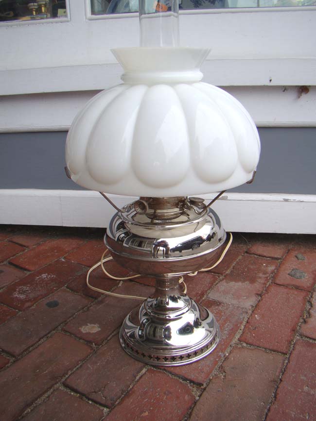 An attractive late 19th century American oil lamp with polished nickel silver base
